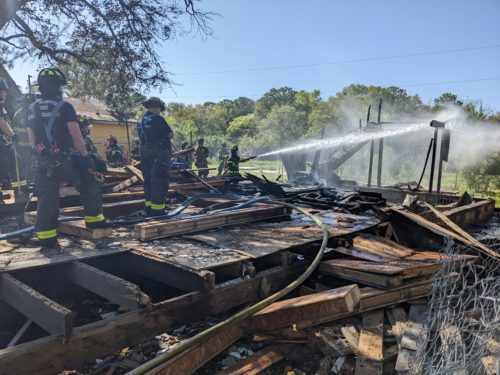 Firefighters putting out the fire that destroyed what remained of the Pine Tree Hotel, April 15, 2021